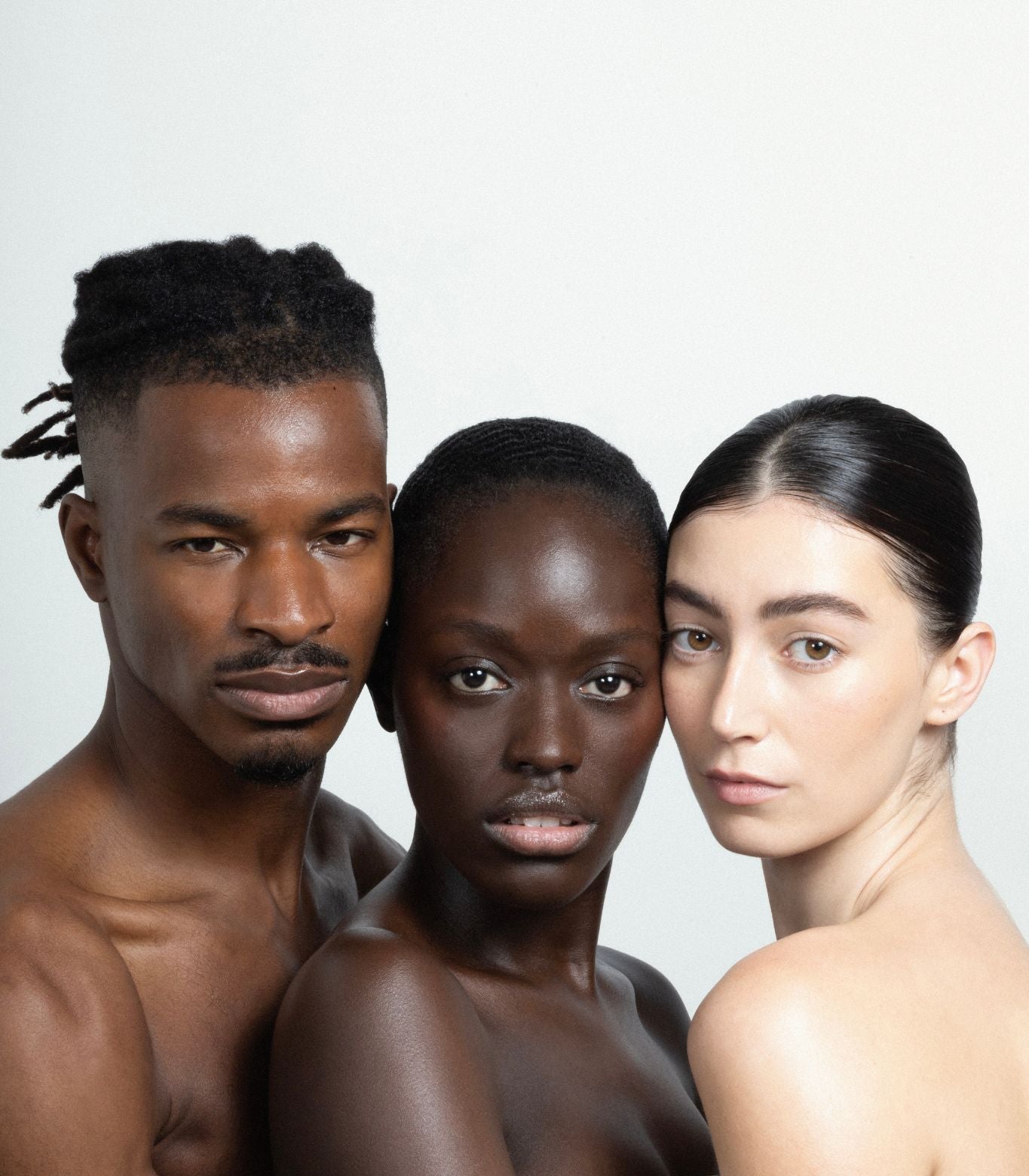 Three melanin inclusive models facing camera