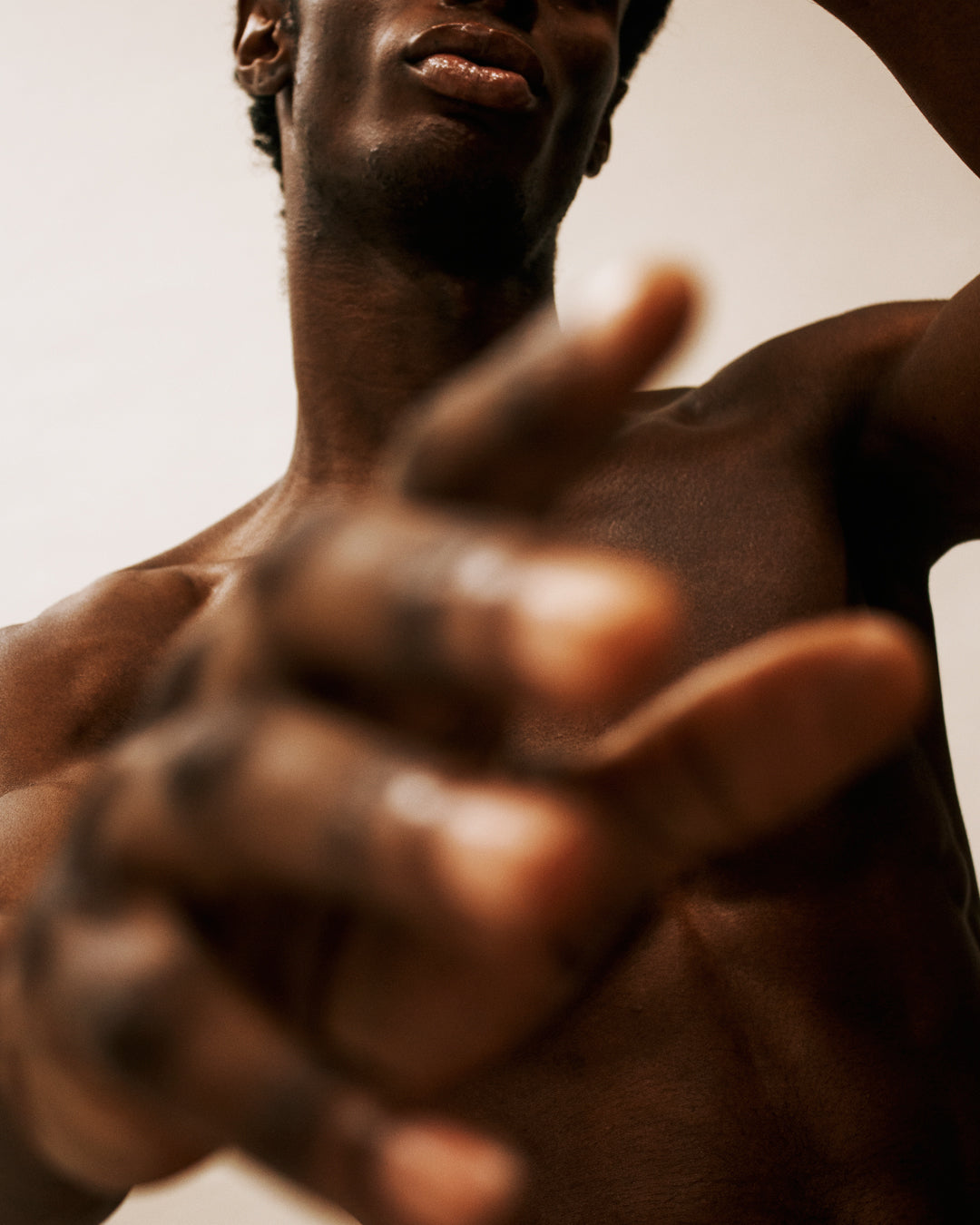 Close up of shirtless man reaching out his hand